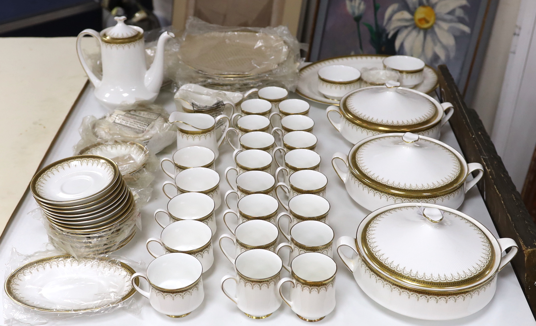 A Paragon Athena pattern blue and gilt tea service including three lidded tureens, oval platter and dinner plates, the largest 38cm wide